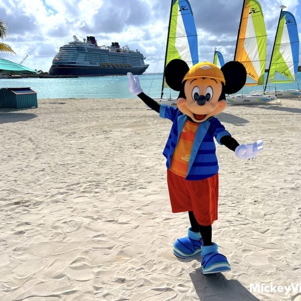 mickey mouse in front of disney cruise ship on castaway cay